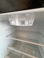 GE 21.9 Cu. Ft. Top-Freezer Refrigerator in Black - Image 5